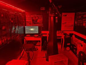 The inside of the Tiny Observatory bathed in red light